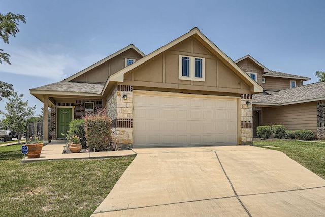 814 Hatton Hill Ct, Austin, TX 78725 - view of front of property with stone siding, driveway, a front yard, and an attached garage