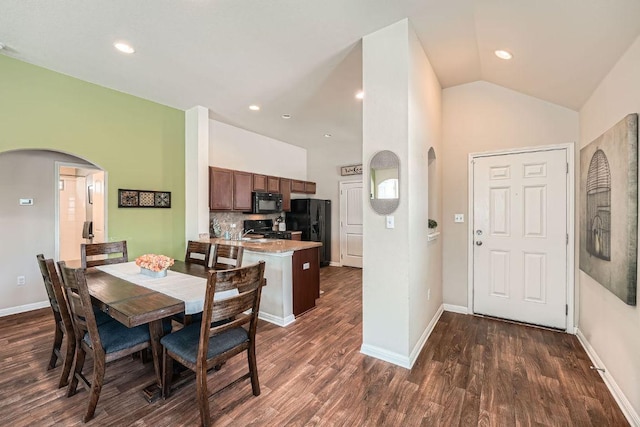814 Hatton Hill Ct, Austin, TX 78725 - dining area featuring arched walkways, dark wood-style flooring, high vaulted ceiling, baseboards, and recessed lighting