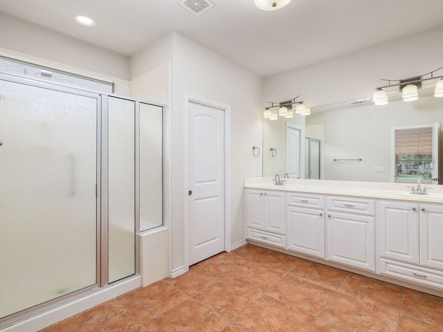 4914 Big Bend Trl, Georgetown, TX 78633 - bathroom featuring a stall shower, double vanity, tile patterned flooring, healthy amount of natural light, and recessed lighting
