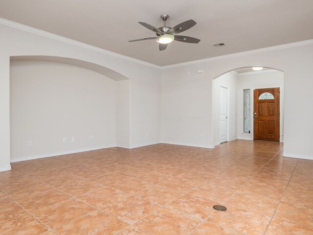 4914 Big Bend Trl, Georgetown, TX 78633 - spare room featuring arched walkways, ceiling fan, ornamental molding, baseboards, and light tile patterned flooring