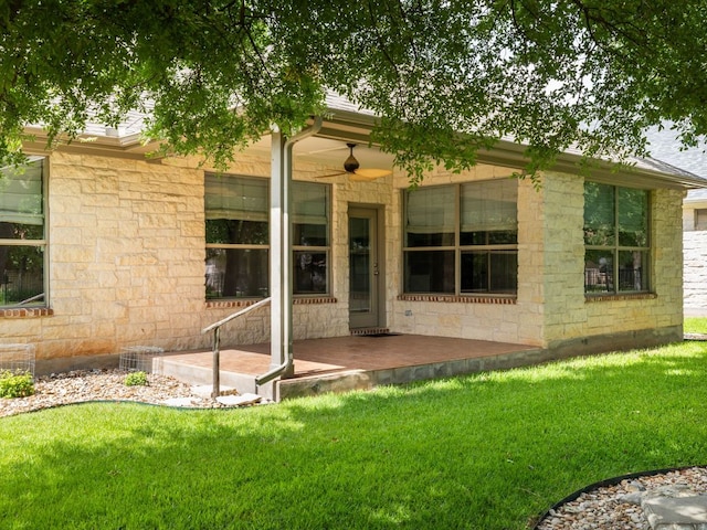 4914 Big Bend Trl, Georgetown, TX 78633 - rear view of property featuring stone siding, a lawn, and a ceiling fan