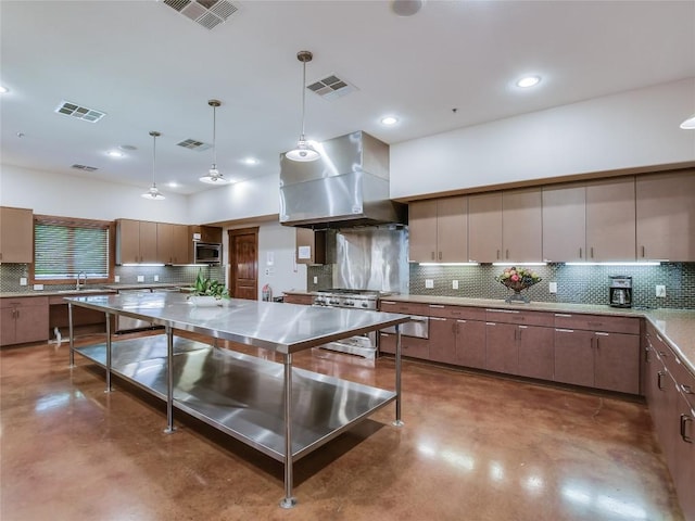 4914 Big Bend Trl, Georgetown, TX 78633 - kitchen featuring wall chimney range hood, concrete floors, stainless steel appliances, backsplash, and recessed lighting