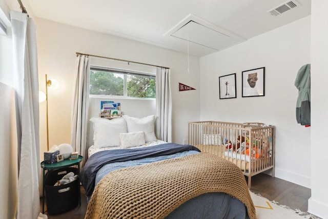 6505 Grover Ave Unit 1, Austin, TX 78757 - bedroom featuring attic access, wood finished floors, and baseboards