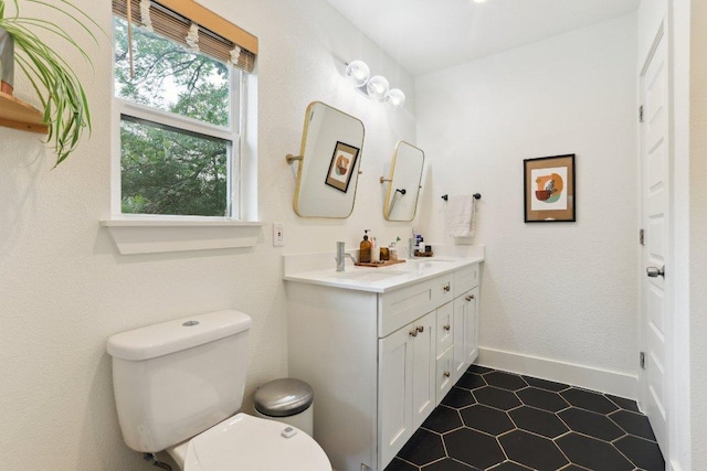 6505 Grover Ave Unit 1, Austin, TX 78757 - bathroom featuring double vanity, toilet, and tile patterned floors