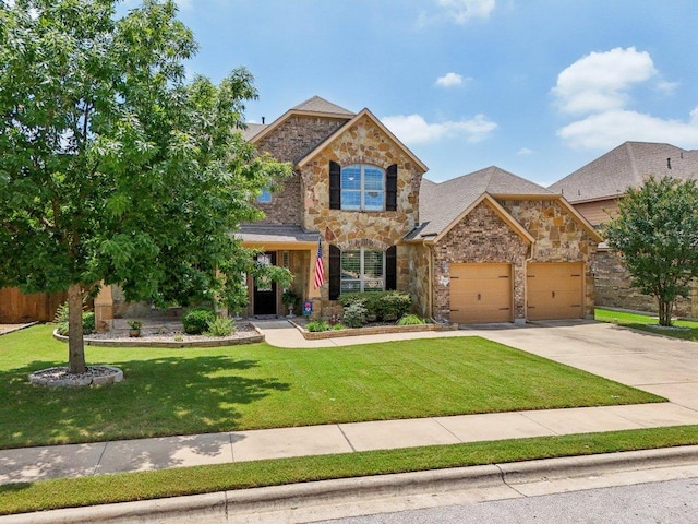 2513 Rusty Spur, Leander, TX 78641 - view of front of home with stone siding, a garage, driveway, and a front yard