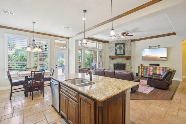 2513 Rusty Spur, Leander, TX 78641 - kitchen with a sink, stone tile flooring, stainless steel dishwasher, crown molding, and baseboards