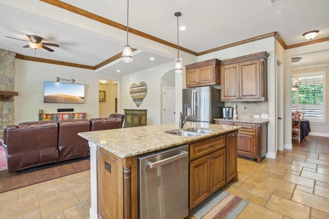2513 Rusty Spur, Leander, TX 78641 - kitchen featuring appliances with stainless steel finishes, open floor plan, stone tile floors, light stone countertops, and decorative light fixtures
