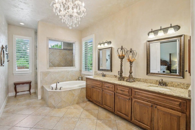2513 Rusty Spur, Leander, TX 78641 - ensuite bathroom featuring a bath, double vanity, tile patterned floors, and a chandelier