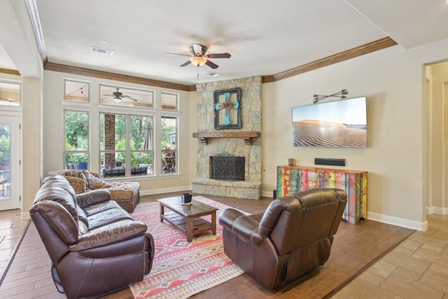 2513 Rusty Spur, Leander, TX 78641 - living room featuring ceiling fan, crown molding, plenty of natural light, a fireplace, and baseboards