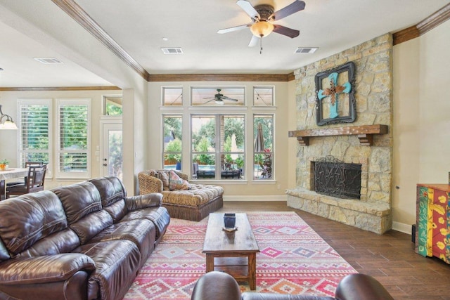 2513 Rusty Spur, Leander, TX 78641 - living area featuring a ceiling fan, a fireplace, wood finished floors, crown molding, and baseboards
