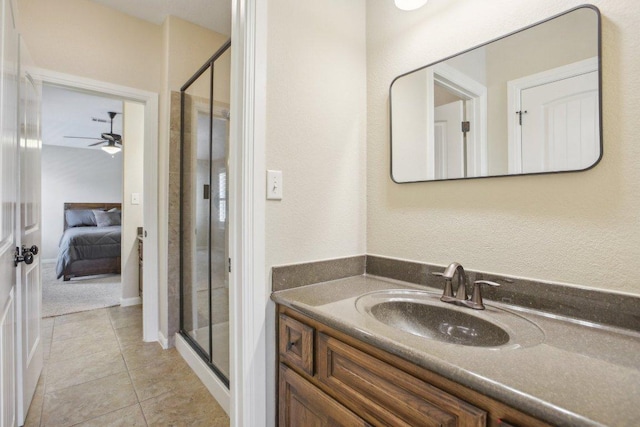 2513 Rusty Spur, Leander, TX 78641 - ensuite bathroom featuring a shower stall, vanity, a ceiling fan, and tile patterned floors