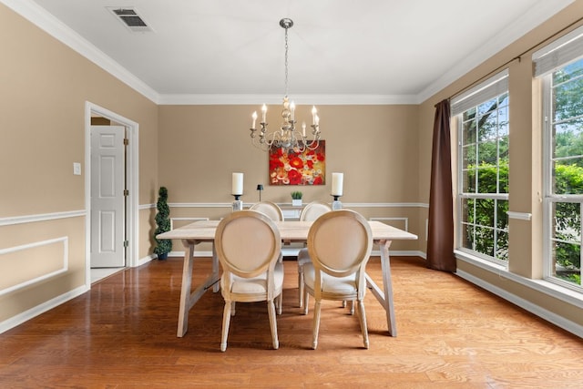 10617 Bramblecrest Dr, Austin, TX 78726 - dining room with a chandelier, light wood-type flooring, crown molding, and baseboards