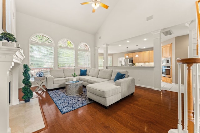 10617 Bramblecrest Dr, Austin, TX 78726 - living area with decorative columns, a ceiling fan, wood finished floors, high vaulted ceiling, and recessed lighting
