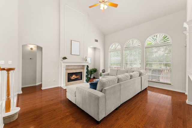 10617 Bramblecrest Dr, Austin, TX 78726 - living room with high vaulted ceiling, a fireplace with flush hearth, ceiling fan, arched walkways, and baseboards