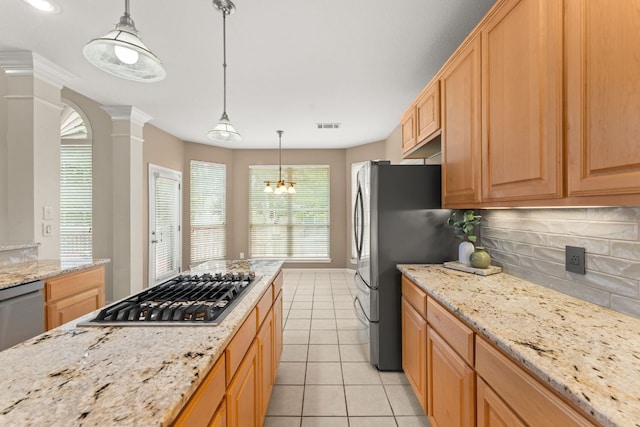 10617 Bramblecrest Dr, Austin, TX 78726 - kitchen featuring appliances with stainless steel finishes, ornate columns, tasteful backsplash, light tile patterned floors, and light stone countertops