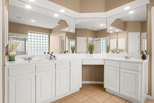 10617 Bramblecrest Dr, Austin, TX 78726 - bathroom featuring a shower stall, tile patterned floors, double vanity, and recessed lighting