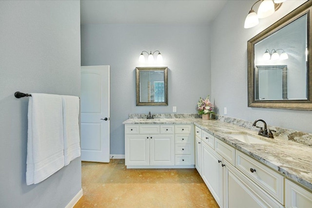 141 N Buckhorn Dr, Bastrop, TX 78602 - full bathroom featuring double vanity, baseboards, and concrete floors