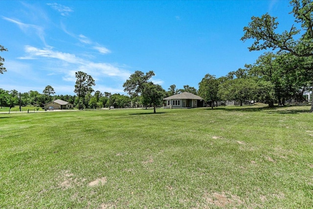 141 N Buckhorn Dr, Bastrop, TX 78602 - view of green lawn with view of wooded area