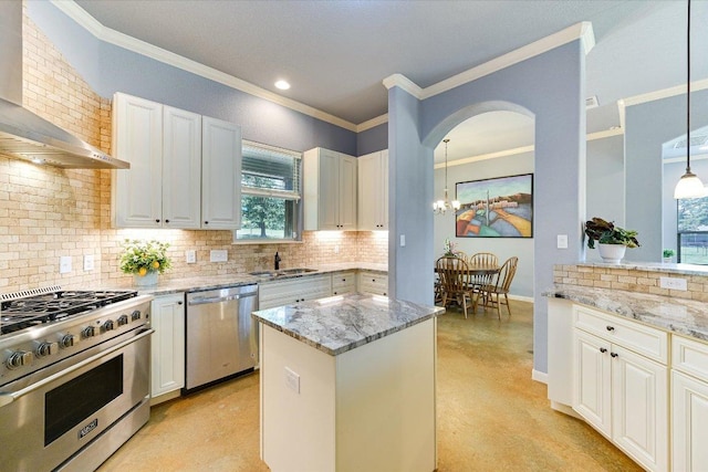 141 N Buckhorn Dr, Bastrop, TX 78602 - kitchen with stainless steel appliances, wall chimney exhaust hood, decorative backsplash, a sink, and ornamental molding