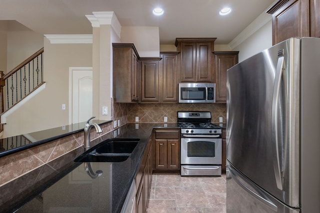 11000 Anderson Mill Rd Unit 96, Austin, TX 78750 - kitchen with appliances with stainless steel finishes, a sink, ornamental molding, dark stone countertops, and backsplash