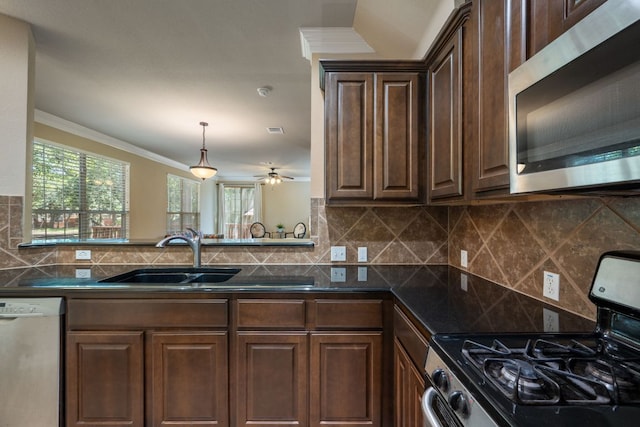 11000 Anderson Mill Rd Unit 96, Austin, TX 78750 - kitchen with stainless steel microwave, range with gas stovetop, dishwasher, dark countertops, and ornamental molding