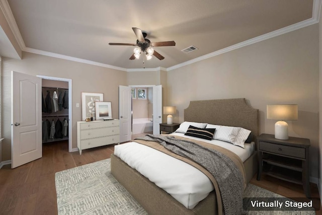 11000 Anderson Mill Rd Unit 96, Austin, TX 78750 - bedroom featuring wood finished floors, a walk in closet, crown molding, a closet, and baseboards