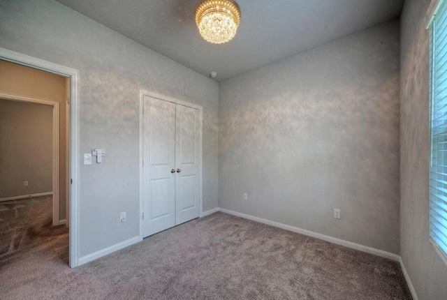 211 S Timber Brook Dr, Hutto, TX 78634 - unfurnished bedroom featuring carpet floors, a chandelier, and a closet
