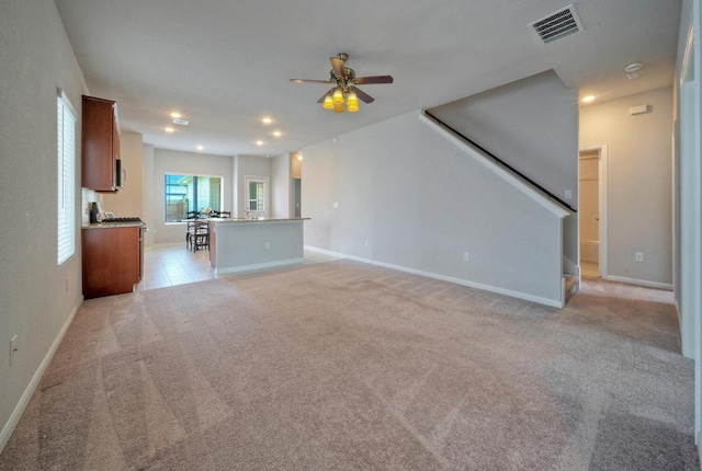211 S Timber Brook Dr, Hutto, TX 78634 - unfurnished living room featuring ceiling fan, light colored carpet, recessed lighting, and stairway