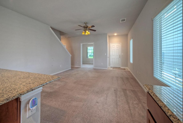 211 S Timber Brook Dr, Hutto, TX 78634 - unfurnished living room featuring light carpet, a ceiling fan, baseboards, and stairway