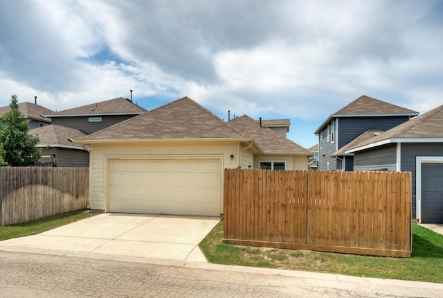 211 S Timber Brook Dr, Hutto, TX 78634 - view of front of house with a garage, concrete driveway, and a shingled roof