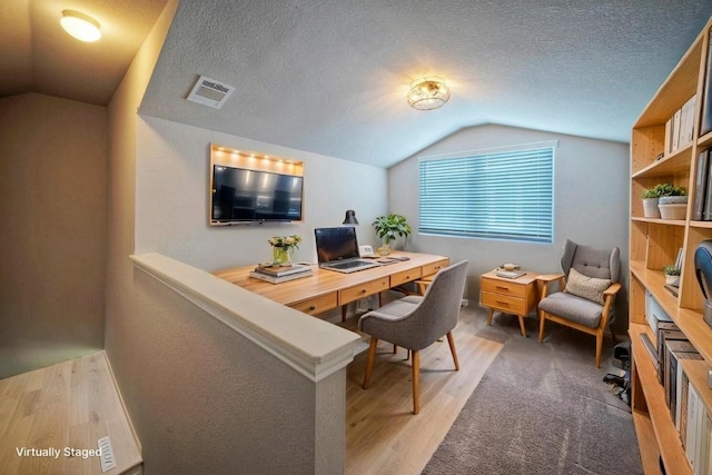 211 S Timber Brook Dr, Hutto, TX 78634 - office with vaulted ceiling, light wood-type flooring, and a textured ceiling