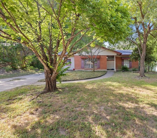 6805 Tulane Dr, Austin, TX 78723 - ranch-style house with brick siding, a front lawn, and roof mounted solar panels
