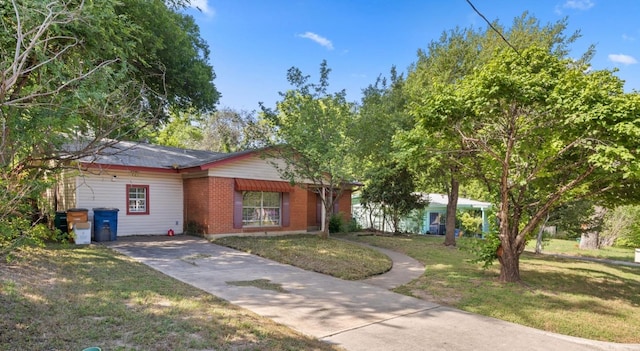 6805 Tulane Dr, Austin, TX 78723 - single story home featuring brick siding, a front lawn, and driveway