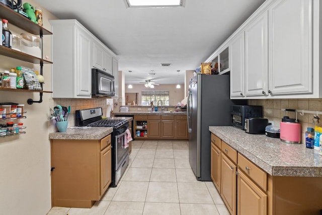 6805 Tulane Dr, Austin, TX 78723 - kitchen featuring stainless steel appliances, decorative backsplash, light tile patterned floors, white cabinets, and a ceiling fan