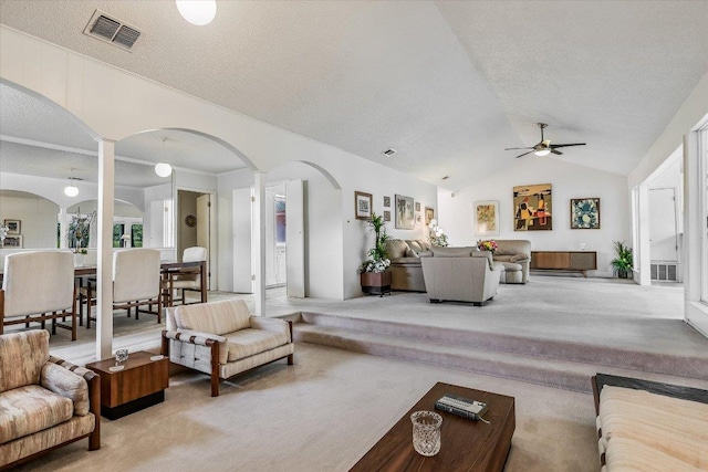 8600 Crest Ridge Cir, Austin, TX 78750 - living room with ornate columns, arched walkways, lofted ceiling, light carpet, and ceiling fan