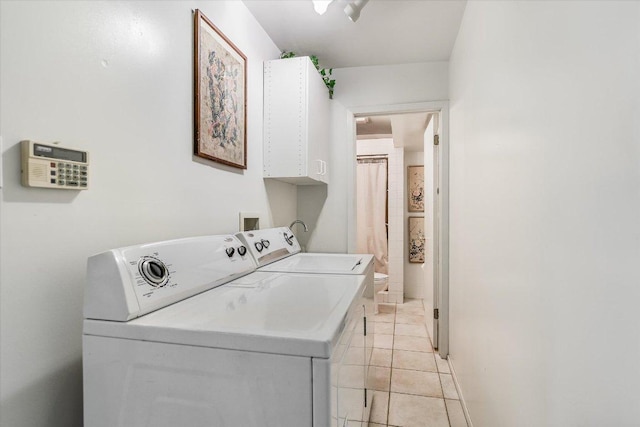 8600 Crest Ridge Cir, Austin, TX 78750 - laundry area with cabinet space, washing machine and clothes dryer, and light tile patterned floors