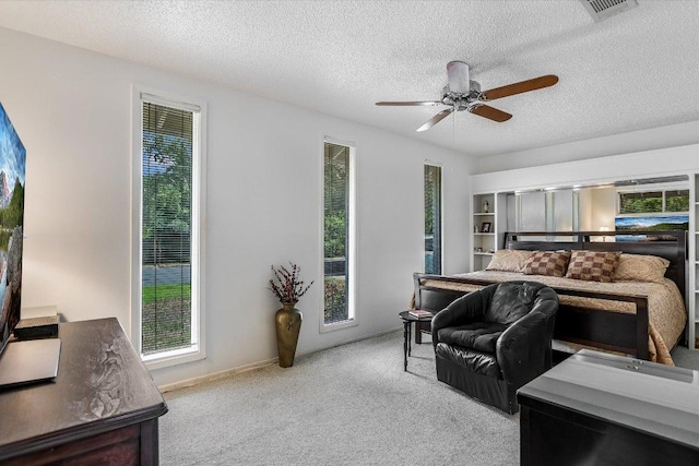 8600 Crest Ridge Cir, Austin, TX 78750 - carpeted bedroom with a textured ceiling, a ceiling fan, and a heating unit