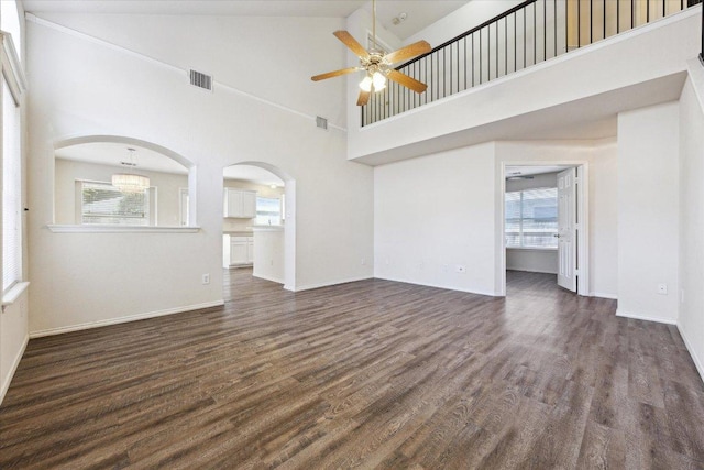 14321 Harcourt House Ln, Pflugerville, TX 78660 - unfurnished living room featuring plenty of natural light, ceiling fan, dark wood-style floors, and a high ceiling