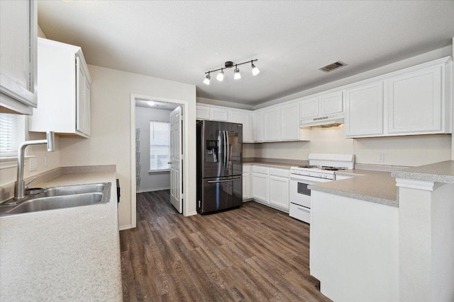 14321 Harcourt House Ln, Pflugerville, TX 78660 - kitchen with refrigerator with ice dispenser, white gas range oven, a sink, under cabinet range hood, and dark wood-style floors