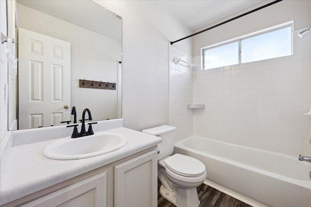 14321 Harcourt House Ln, Pflugerville, TX 78660 - bathroom with toilet, washtub / shower combination, vanity, and wood finished floors