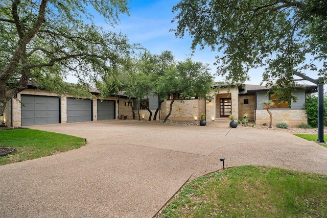332 Rugged Earth Dr, Austin, TX 78737 - view of front of property with concrete driveway, stone siding, and a garage