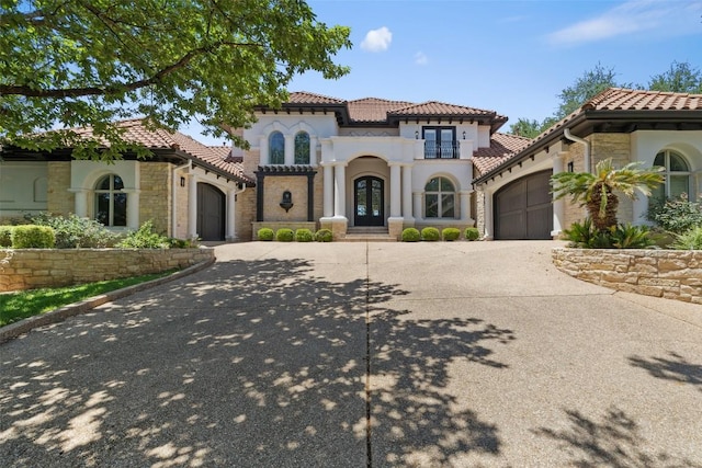 2404 University Club Dr, Austin, TX 78732 - mediterranean / spanish home featuring a garage, driveway, french doors, and a tiled roof