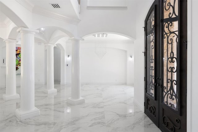 2404 University Club Dr, Austin, TX 78732 - foyer with marble tiled flooring, crown molding, and arched walkways