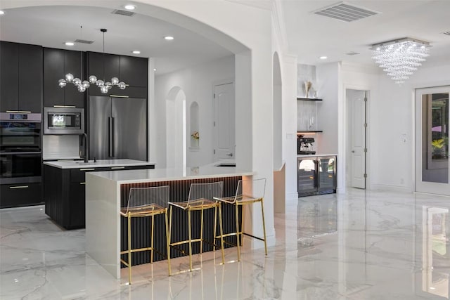 2404 University Club Dr, Austin, TX 78732 - kitchen with a kitchen island with sink, dark cabinets, modern cabinets, stainless steel appliances, and wine cooler