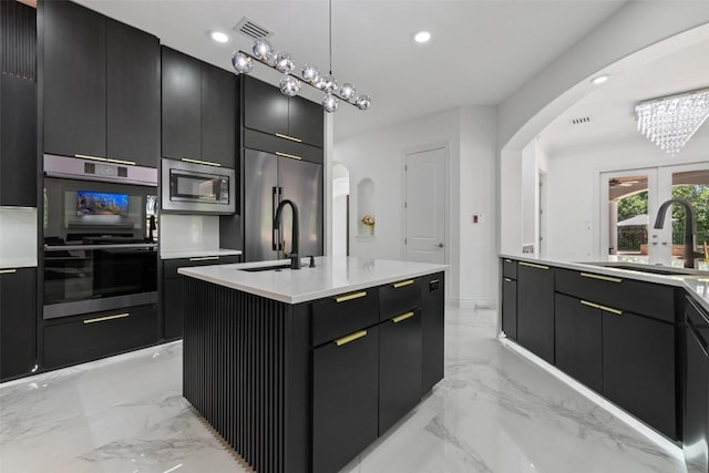 2404 University Club Dr, Austin, TX 78732 - kitchen with arched walkways, built in appliances, a sink, modern cabinets, and recessed lighting