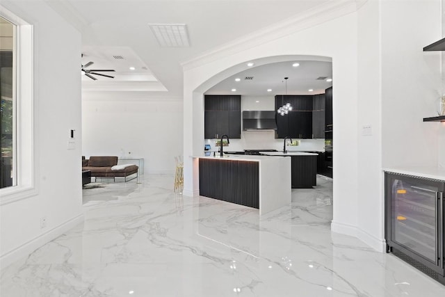2404 University Club Dr, Austin, TX 78732 - kitchen with modern cabinets, dark cabinetry, ventilation hood, wine cooler, and light marble finish flooring