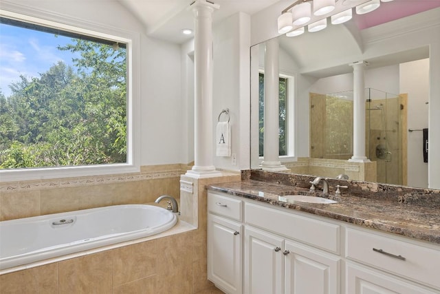 2404 University Club Dr, Austin, TX 78732 - bathroom featuring decorative columns, a shower stall, a garden tub, vanity, and plenty of natural light
