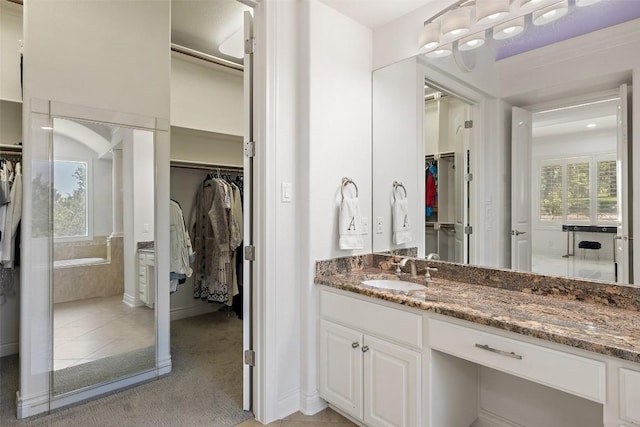 2404 University Club Dr, Austin, TX 78732 - full bath featuring a spacious closet, vanity, plenty of natural light, and baseboards