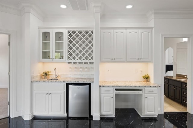 2404 University Club Dr, Austin, TX 78732 - kitchen featuring stainless steel refrigerator, white cabinets, a sink, glass insert cabinets, and light stone countertops