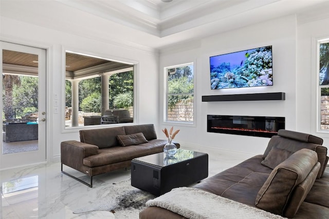 2404 University Club Dr, Austin, TX 78732 - living room featuring marble tiled flooring, healthy amount of natural light, a glass covered fireplace, and crown molding